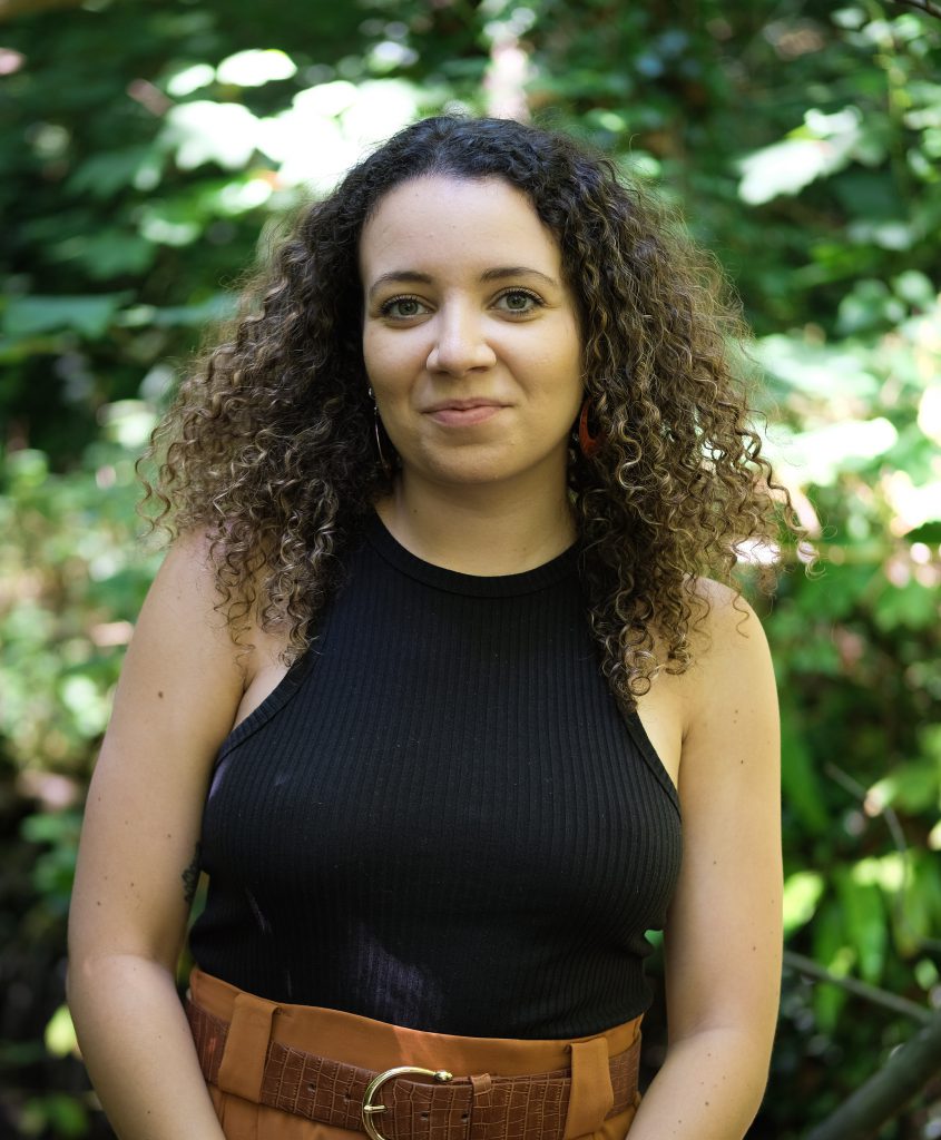 Portrait of Taylor Edmonds with blurred trees in the background.